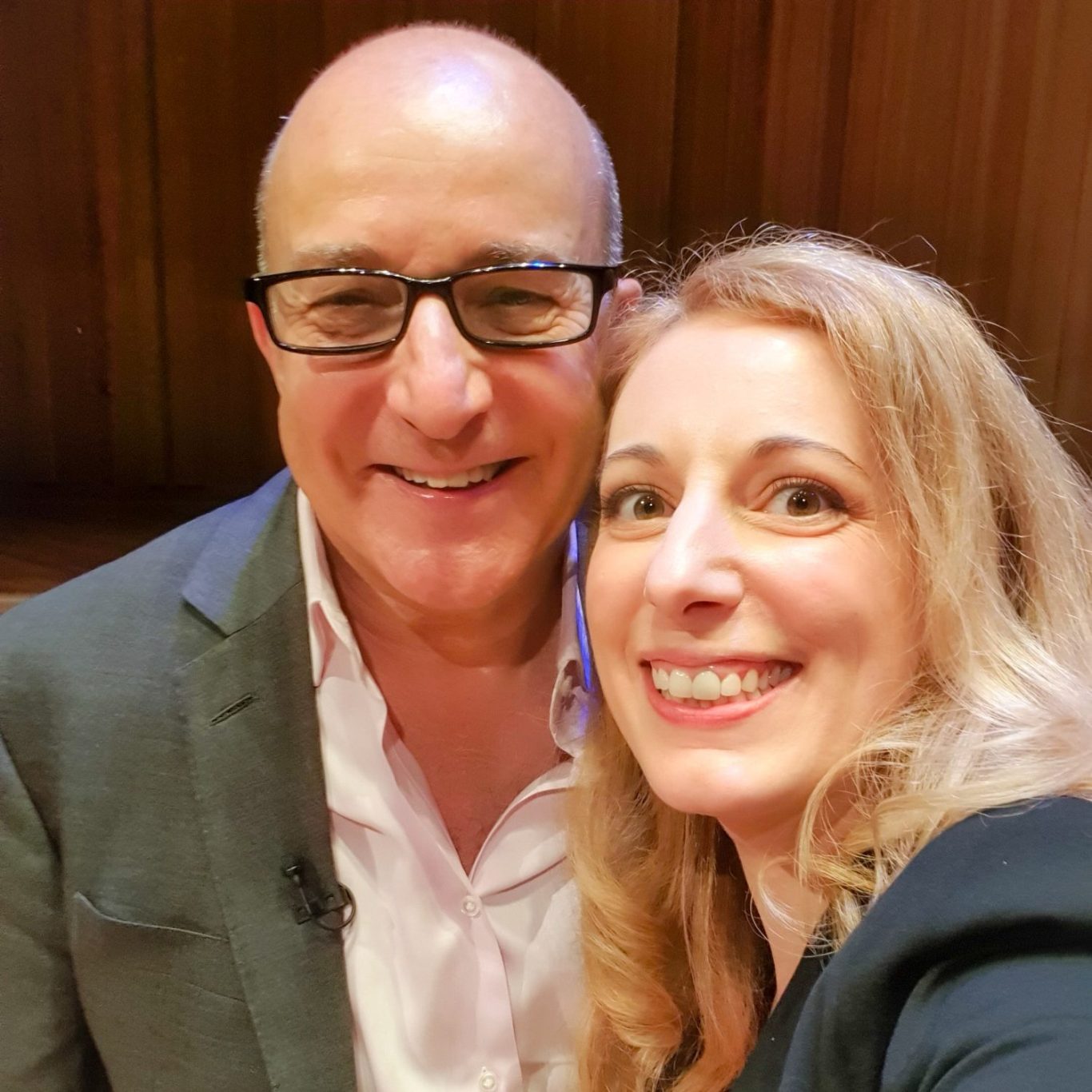 Smiling Paul McKenna and Rebecca posing for a selfie in a professional setting.